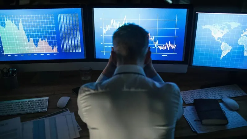 A declining stock chart overlaid with digital data, representing the 2026 crypto industry shakeout