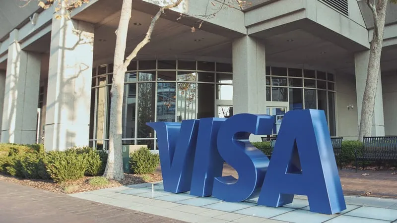 The Visa logo on the exterior of a corporate office building