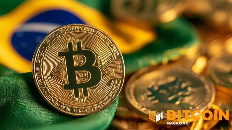 A gold Bitcoin coin in front of a Brazilian flag